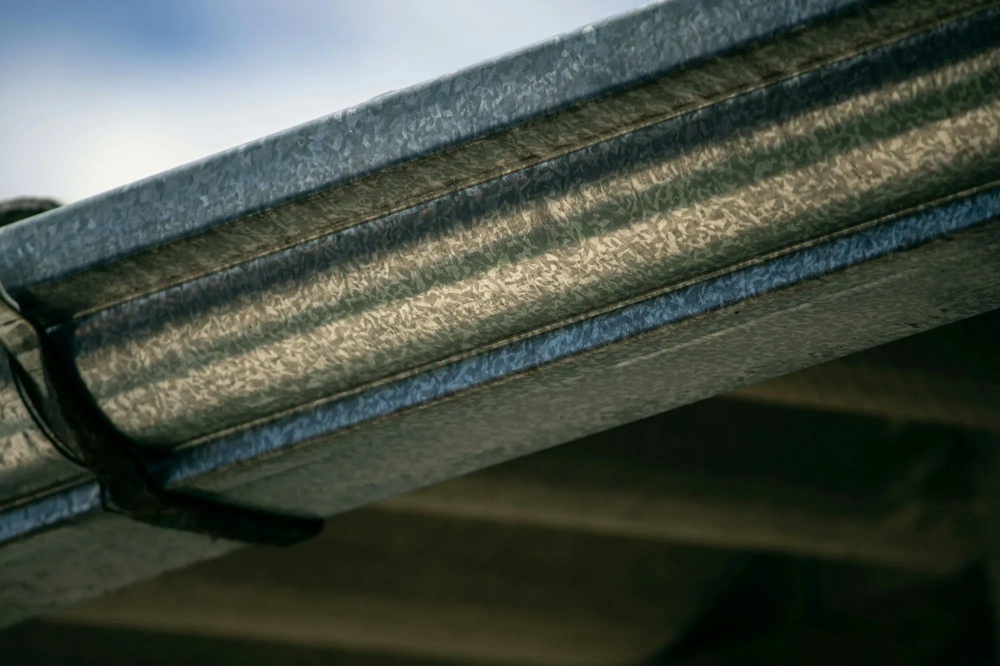 Close-up of a metal gutter running along the edge of a roof